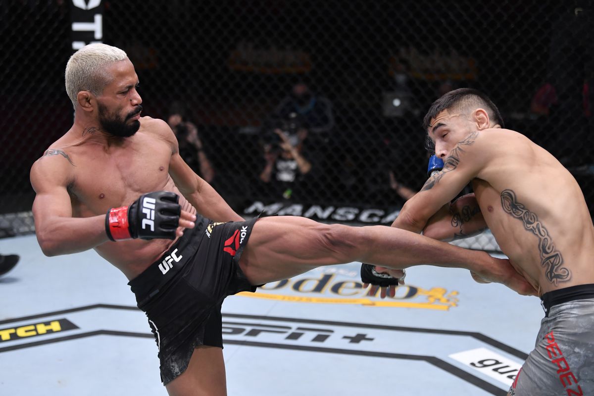 In this handout image provided by UFC, (L-R) Deiveson Figueiredo of Brazil kicks Alex Perez in their flyweight championship bout during the UFC 255 event at UFC APEX on November 21, 2020 in Las Vegas, Nevada.