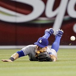 Los Angeles Dodgers center fielder Skip Schumaker  dives but misses a ball hit by San Diego Padres' Kyle Blanks (not pictured) for an RBI single in the third inning during a baseball game Friday, June 21, 2013, in San Diego. 