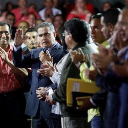Venezuela's ombudsman Tarek William Saab, center, is congratulated by the members of Constitutional Assembly after he was sworn-in as the nation's new General Prosecutor during the first session of Constitutional Assembly in Caracas, Venezuela, Saturday, Aug. 5, 2017. A newly installed Constitutional Assembly ousted Venezuela's defiant chief prosecutor, a sign that President Nicolas Maduro's embattled government intends to move swiftly against critics and consolidate power amid a fast-moving political crisis.