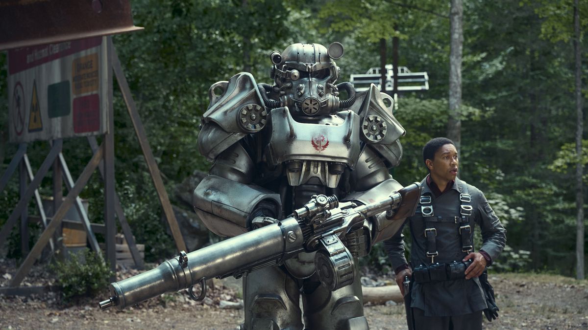 A person in power armor stands next to a regular person in an image from Amazon Prime Video’s Fallout series