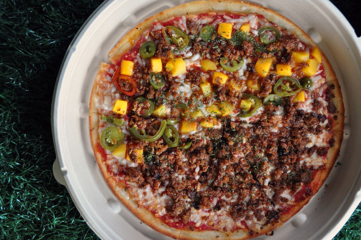 A half-and-half pizza of the Georgia Peach and Vegan Meat Lovers, two of the most popular flavors at the newly opened Plant Based Pizzeria.
