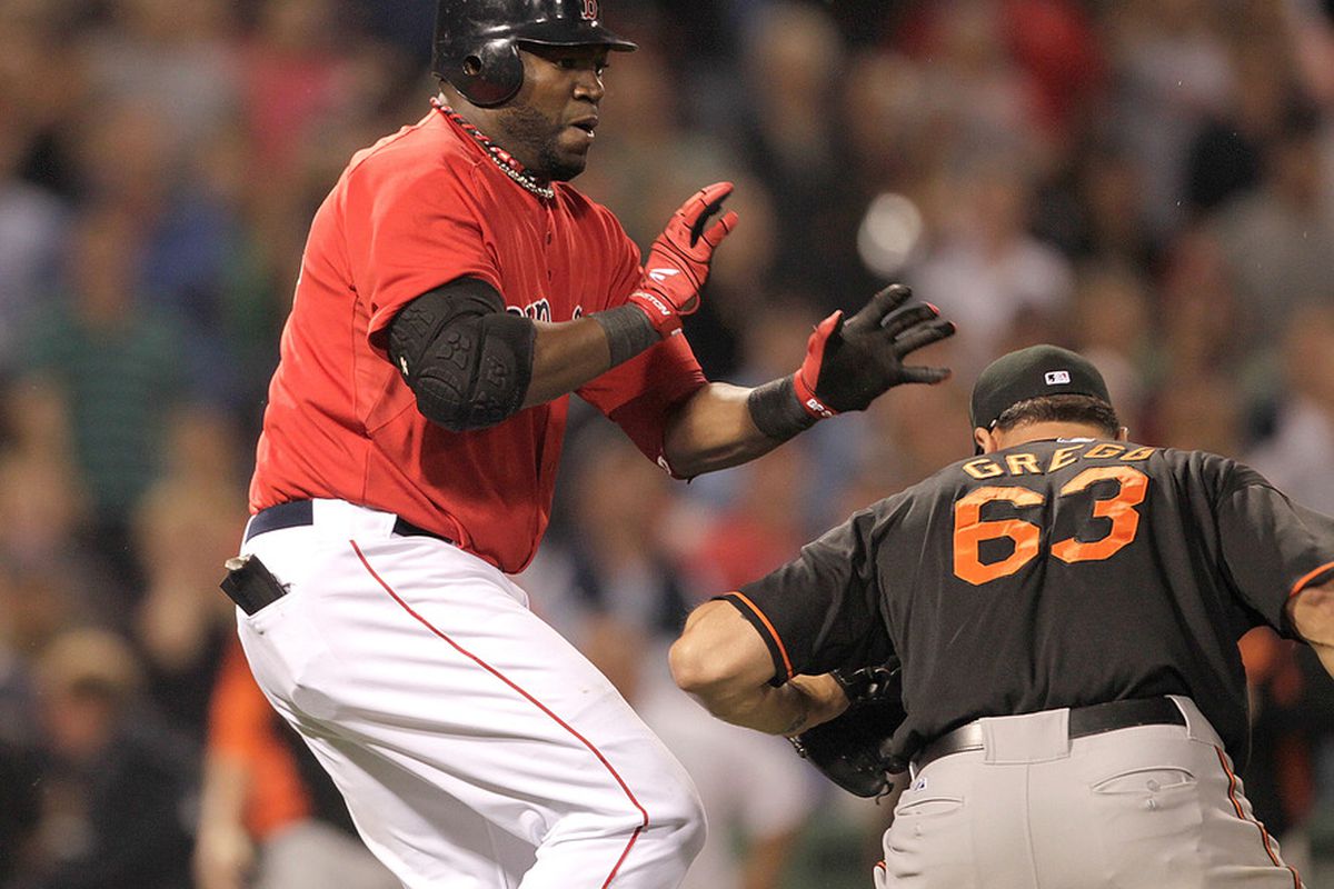 BOSTON, MA - JULY 8:  David Ortiz #34 of the Boston Red Sox and pitcher Kevin Gregg #63 of the Baltimore Orioles fight in the bottom of the eighth inning at Fenway Park on July 8, 2011 in Boston, Massachusetts.  (Photo by Jim Rogash/Getty Images)