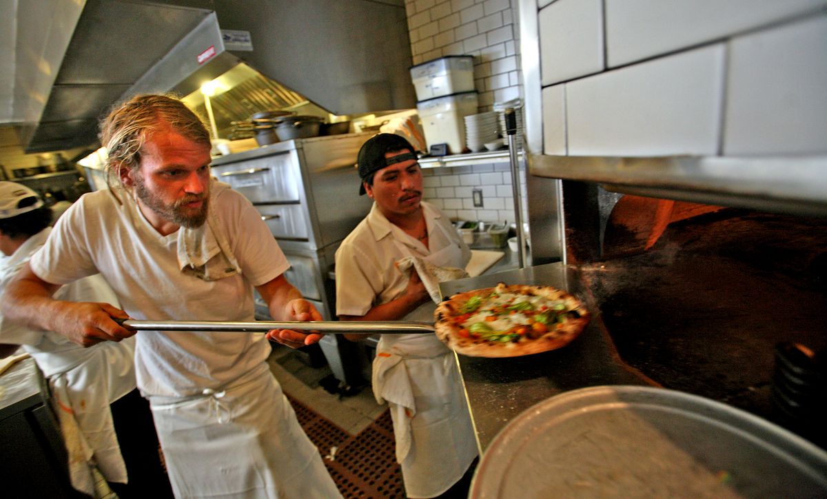 Chef Travis Lett pulls a pizza from the oven, at Gjelina restaurant in Venice on APRIL 27, 2011.