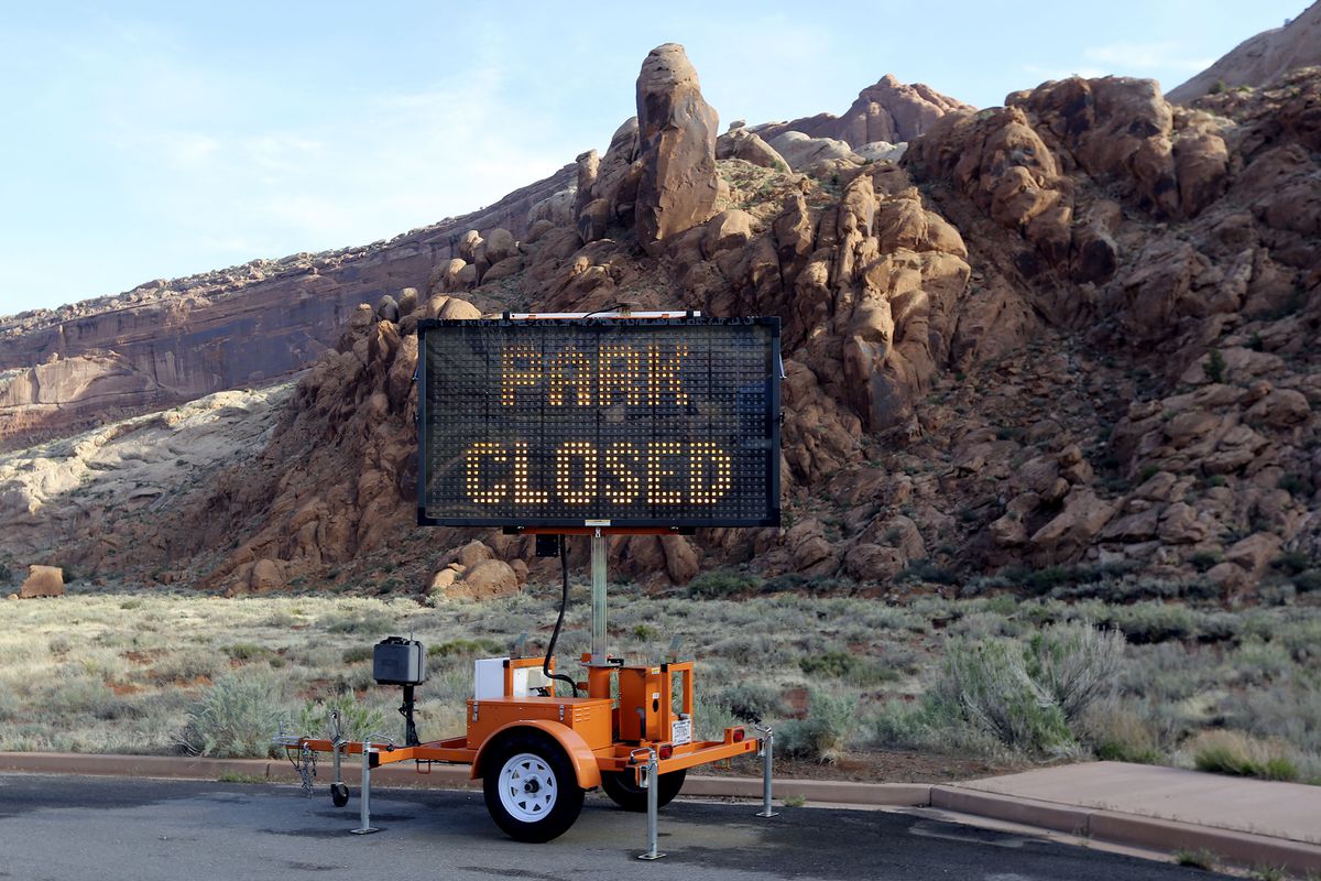 A sign alerts visitors that Arches National Park outside of Moab&nbsp;is closed due to the coronavirus pandemic on Sunday, April 19, 2020.