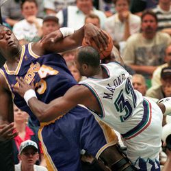 The Lakers' Shaquille O'Neil fouls the Jazz's Karl Malone.
