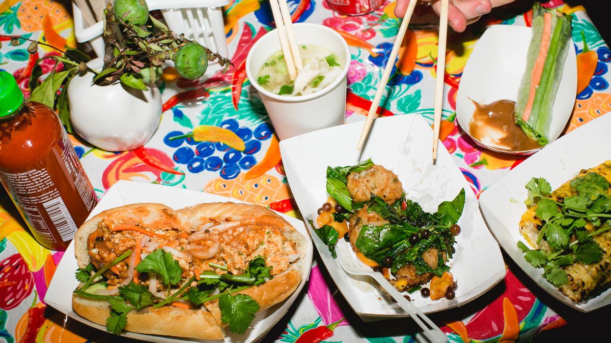 A spread of Rice Paper Scissors food — banh mi, pho, and more —&nbsp;on a colorful tablecloth