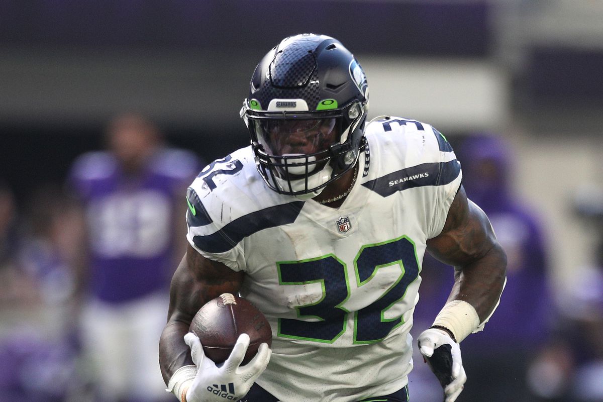 Chris Carson #32 of the Seattle Seahawks runs the ball for a touchdown during the second quarter in the game against the Minnesota Vikings at U.S. Bank Stadium on September 26, 2021 in Minneapolis, Minnesota.