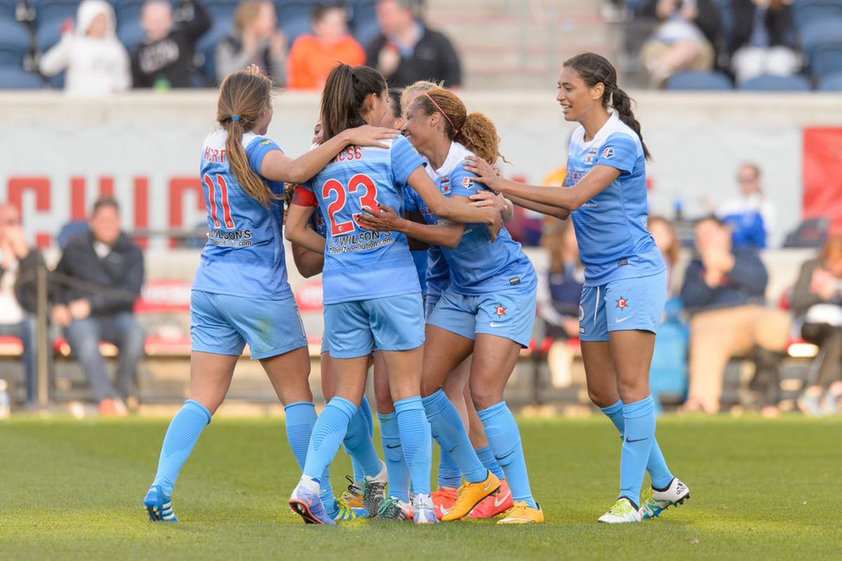 Naperville native Casey Short is surrounded by teammates after scoring her first NWSL goal