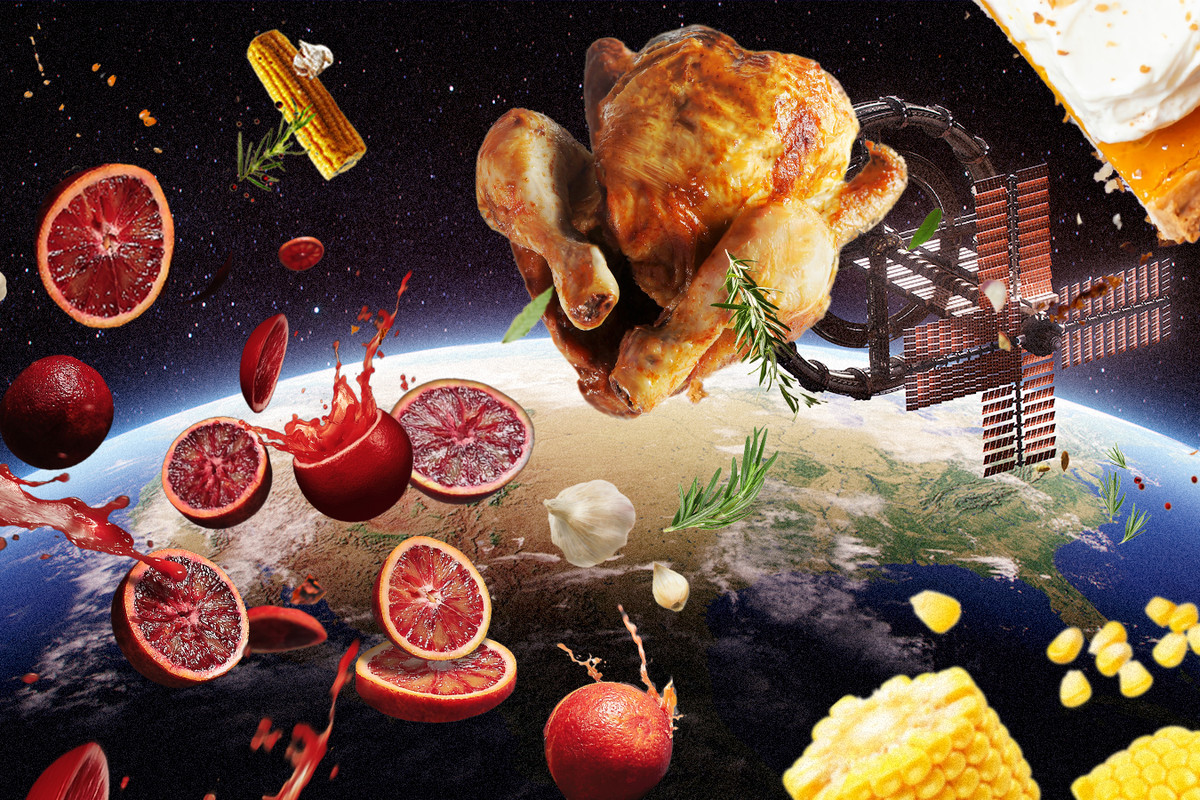A turkey, slices of fruit, corn, and other foods float above the Earth in space.