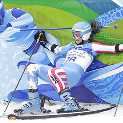 Julia Mancuso of the United States falls back on to the finish area fencing after finishing the second run of the women's giant slalom at the Vancouver 2010 Olympics in Whistler, British Columbia, Thursday.