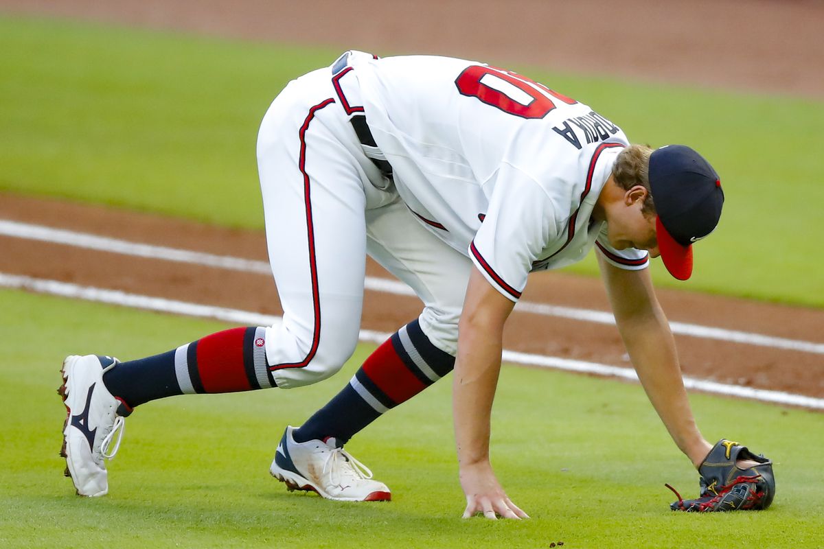Mike Soroka #40 of the Atlanta Braves takes tot he ground after suffering an injury in the third inning of an MLB game against the New York Mets at Truist Park on August 3, 2020 in Atlanta, Georgia.