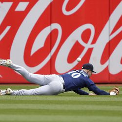 Jarred Kelenic #10 of the Seattle Mariners dives for a ball that goes for an rbi triple hit by Esteury Ruiz #1 of the Oakland Athletics in the bottom of the third inning at RingCentral Coliseum on May 04, 2023 in Oakland, California.