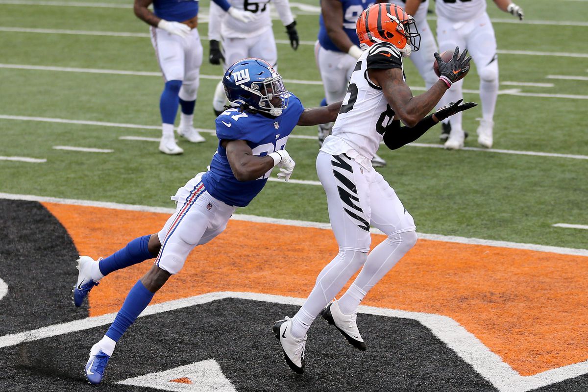 Cincinnati Bengals wide receiver Tee Higgins (85) catches a touchdown pass as New York Giants cornerback Isaac Yiadom (27) defends in the fourth quarter during an NFL Week 12 football game, Sunday, Nov. 29, 2020, at Paul Brown Stadium in Cincinnati. The New York Giants won 19-17.&nbsp;