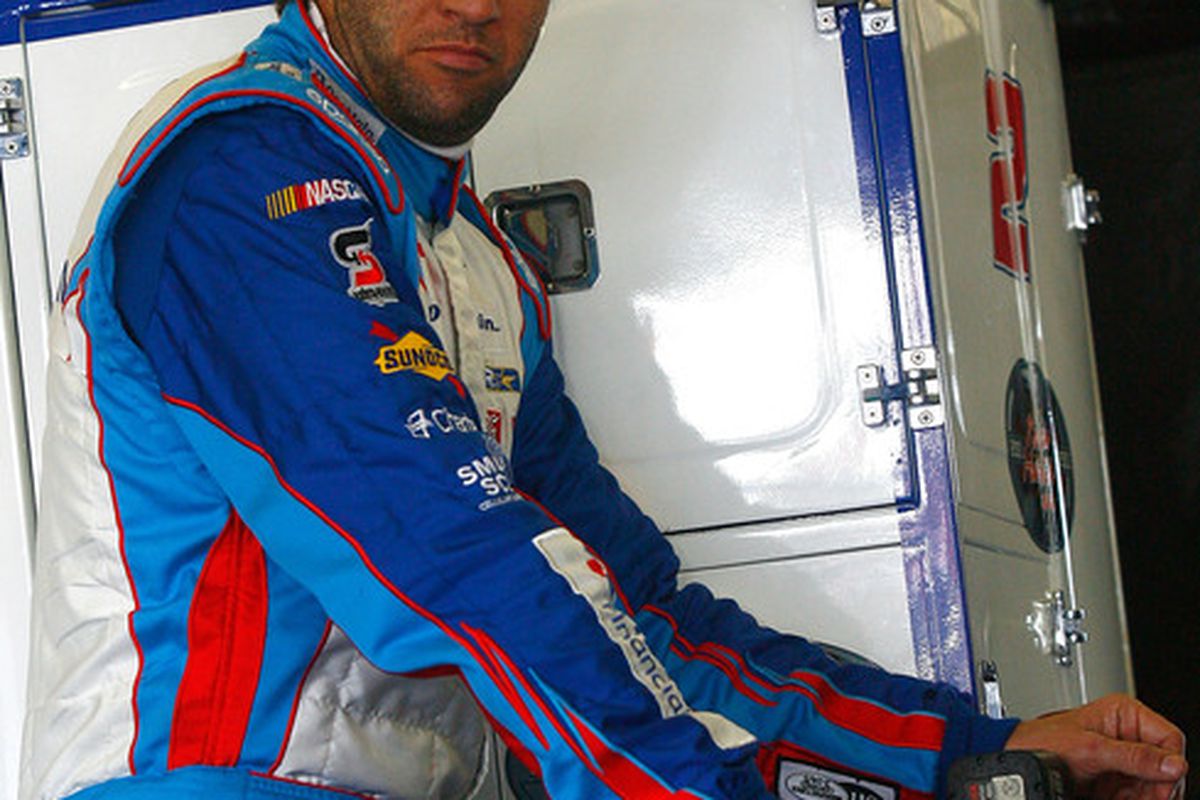 Elliott Sadler stands in the garage area during practice for the NASCAR Nationwide Series Drive4COPD 300 at Daytona International Speedway.