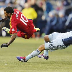 Real's Robbie Findley is brought down Kansas City's Aurelien Collin as Real Salt Lake and Sporting KC play Saturday, Dec. 7, 2013 in MLS Cup action.