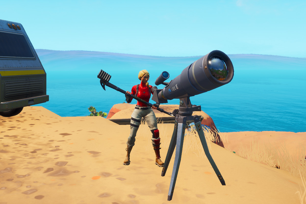 A Fortnite player stands behind a telescope in the middle of the desert