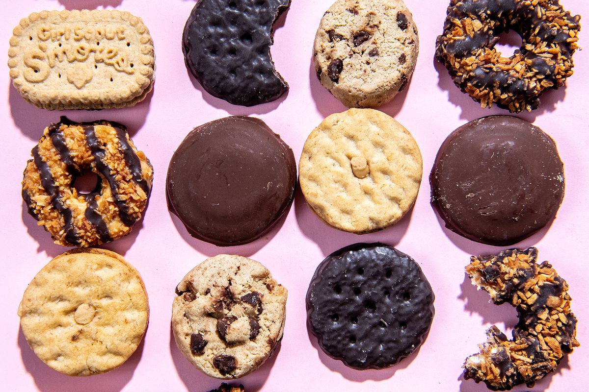 Array of Girl Scout cookies on a pink background.