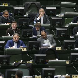 In this photo taken on Sunday, Feb. 19, 2017, lawmakers attend an open session of the Iranian parliament in Tehran, Iran. Iran's parliament voted overwhelmingly Sunday, Aug. 13, to increase spending on its ballistic missile program and the foreign operations of its paramilitary Revolutionary Guard, chanting "Death to America" in a direct challenge to Washington's newest sanctions on the Islamic Republic. (AP Photo/Vahid Salemi)