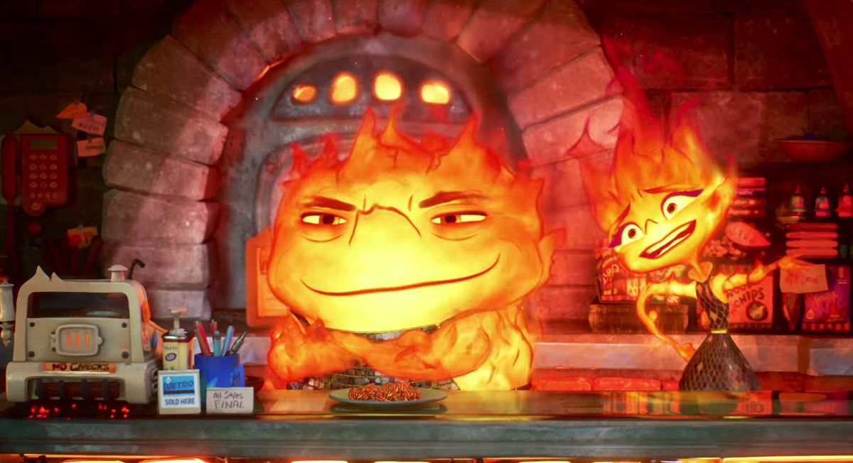 Ember and her smirking fire dad in a fire person restaurant in Pixar’s Elemental