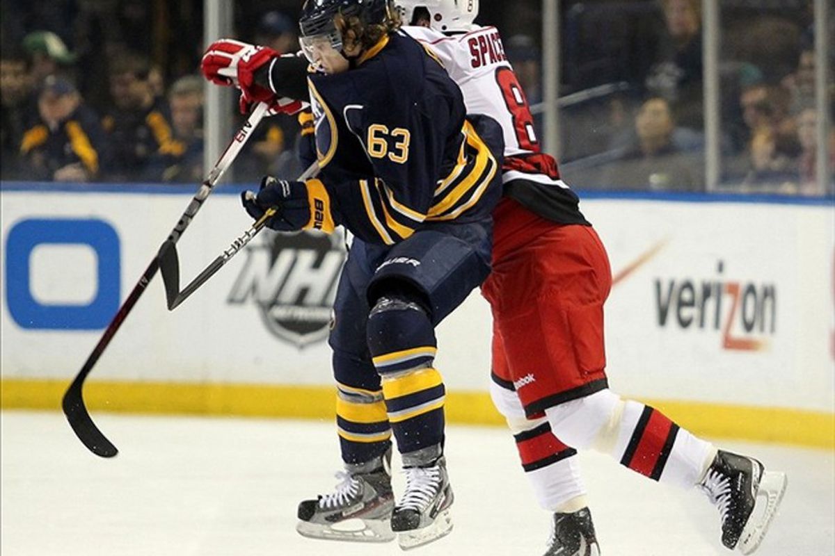 Mar 7, 2012; Buffalo, NY, USA;  Buffalo Sabres left wing Tyler Ennis (63) and Carolina Hurricanes defenseman Jaroslav Spacek (8) collide during the first period at the First Niagara Center.  Mandatory Credit: Timothy T. Ludwig-US PRESSWIRE