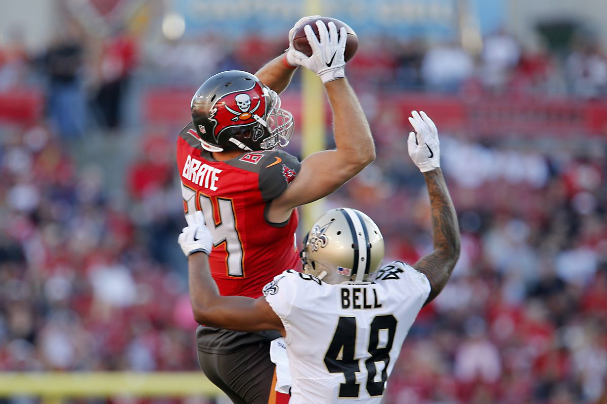TAMPA, FL: Tampa Bay Buccaneers tight end Cameron Brate (84) goes up to make a catch over New Orleans Saints safety Vonn Bell (48) during a game at Raymond James Stadium.