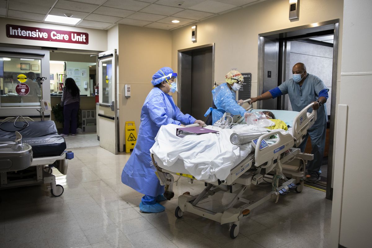 A patient is wheeled out of the Intensive Care Unit at Roseland Community Hospital on the Far South Side last December.