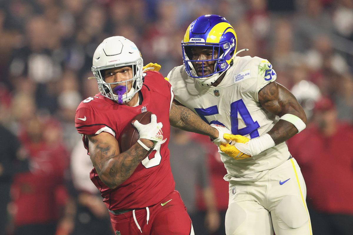 Running back James Conner #6 of the Arizona Cardinals rushes the football against Leonard Floyd #54 of the Los Angeles Rams during the NFL game at State Farm Stadium on December 13, 2021 in Glendale, Arizona. The Rams defeated the Cardinals 30-23.