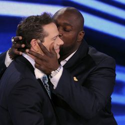 Feb 2, 2013; New Orleans, LA, USA; NFL former player Warren Sapp (right) kisses sportscaster Chris Rose after being selected to the pro football hall of fame during a NFL Network presentation at the New Orleans Convention Center. Mandatory Credit: Jack Gr