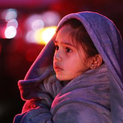 Sade Kelleher, 7, watches as Unified firefighters battle a blaze at Silverwood Estate condominiums in Millcreek on Thursday, Jan. 17, 2019. Kelleher and her mother were forced to flee their apartment.