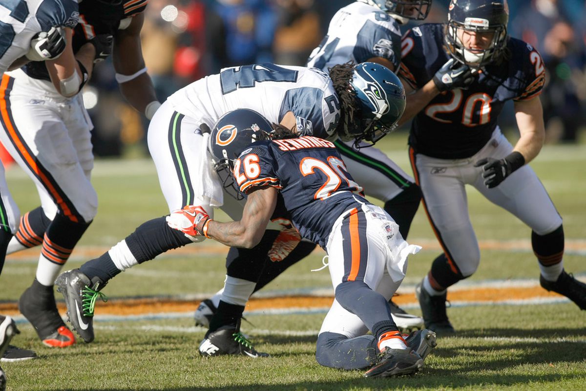 CHICAGO, IL - DECEMBER 18: Marshawn Lynch #24 of the Seattle Seahawks is tackled by  Tim Jennings #26 of the Chicago Bears at Soldier Field on December 18, 2011 in Chicago, Illinois. (Photo by Scott Boehm/Getty Images)