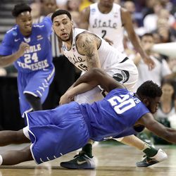 Middle Tennessee's Giddy Potts (20) steals the ball away from Michigan State's Marvin Clark Jr. (15) during the second half of a first-round men's college basketball game in the NCAA Tournament, Friday, March 18, 2016, in St. Louis. Middle Tennessee won 90-81. (AP Photo/Charlie Riedel)
