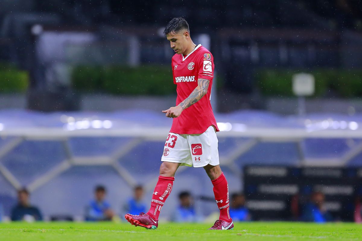 Claudio Baeza of Toluca leaves the field after receiving a red card during the 3rd round match between America and Toluca as part of the Torneo Apertura 2022 Liga MX at Azteca Stadium on July 13, 2022 in Mexico City, Mexico.