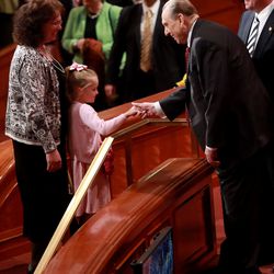 President Thomas S. Monson shakes hands with a young girl at the end of the morning session of the 184th Annual General Conference at the Church of Jesus Christ of Latter-day Saints Conference Center in Salt Lake City on Saturday, April 5, 2014.