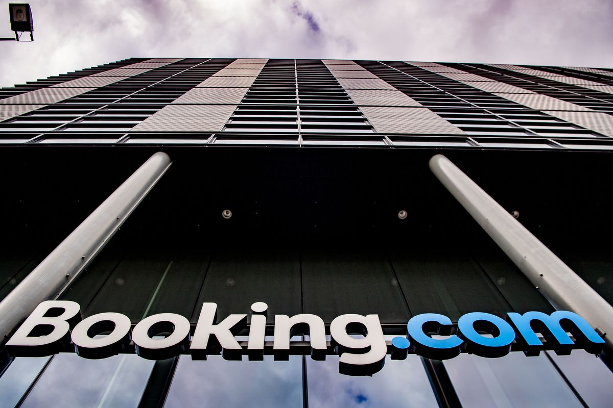 A booking.com logo displayed at the front entrance of the company’s headquarters