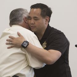 Utah Attorney General Sean Reyes hugs Randy Parker, state director of the U.S. Department of Agriculture Rural Development in Utah, after Parker introduced Reyes at a roundtable discussion about the opioid epidemic that was held  at the Jordan Academy for Technology & Careers South Campus in Riverton on Monday, May 21, 2018.