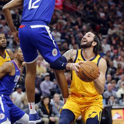 Utah Jazz guard Ricky Rubio fakes LA Clippers guard Tyrone Wallace into the air during NBA action in Salt Lake City on Saturday, Jan. 20, 2018.