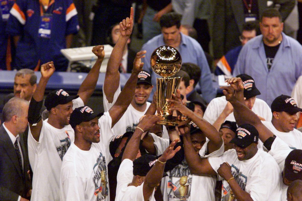 San Antonio Spurs hold up trophy after Spurs beat the New Yo