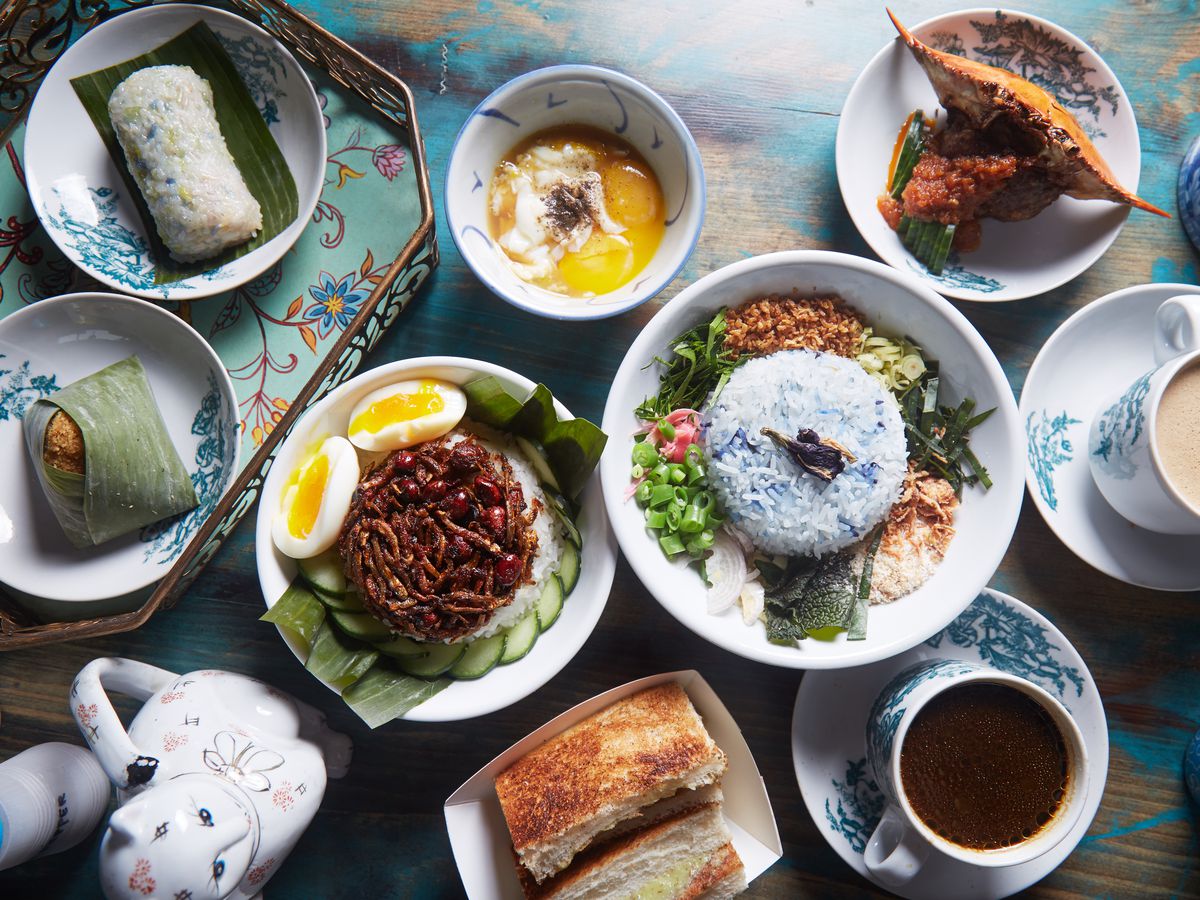 Several dishes take up a tabletop at Kopitiam in New York City.