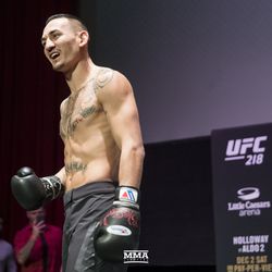 Max Holloway gestures toward the crowd at UFC 218 workouts.