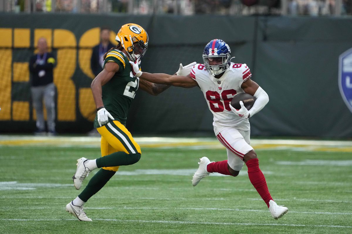 Giants wide receiver Darius Slayton (86) carries the ball as Green Bay Packers cornerback Eric Stokes (21) defends during an NFL International Series game at Tottenham Hotspur Stadium.