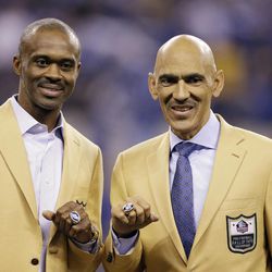 Former Indianapolis Colts' player Marvin Harrison and former head coach Tony Dungy display their Pro Football Hall of Fame rings that were presented to them during halftime of an NFL football game between the Indianapolis Colts and the Pittsburgh Steelers, Thursday, Nov. 24, 2016, in Indianapolis. 