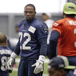 Seattle Seahawks' Robert Turbin, center, talks with quarterback Russell Wilson at practice Wednesday, Jan. 21, 2015, in Renton, Wash. The Seahawks play the New England Patriots in the Super Bowl Feb. 1 in Glendale, Ariz. 