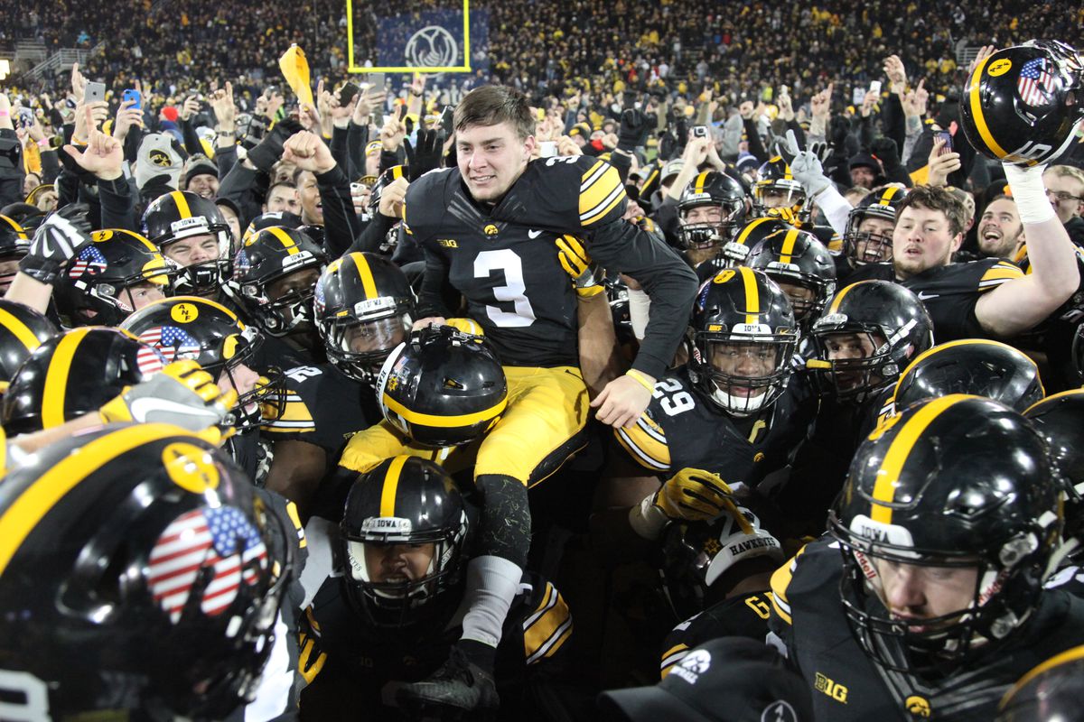 Hawkeyes hoist Keith Duncan after his game-winning kick against Michigan
