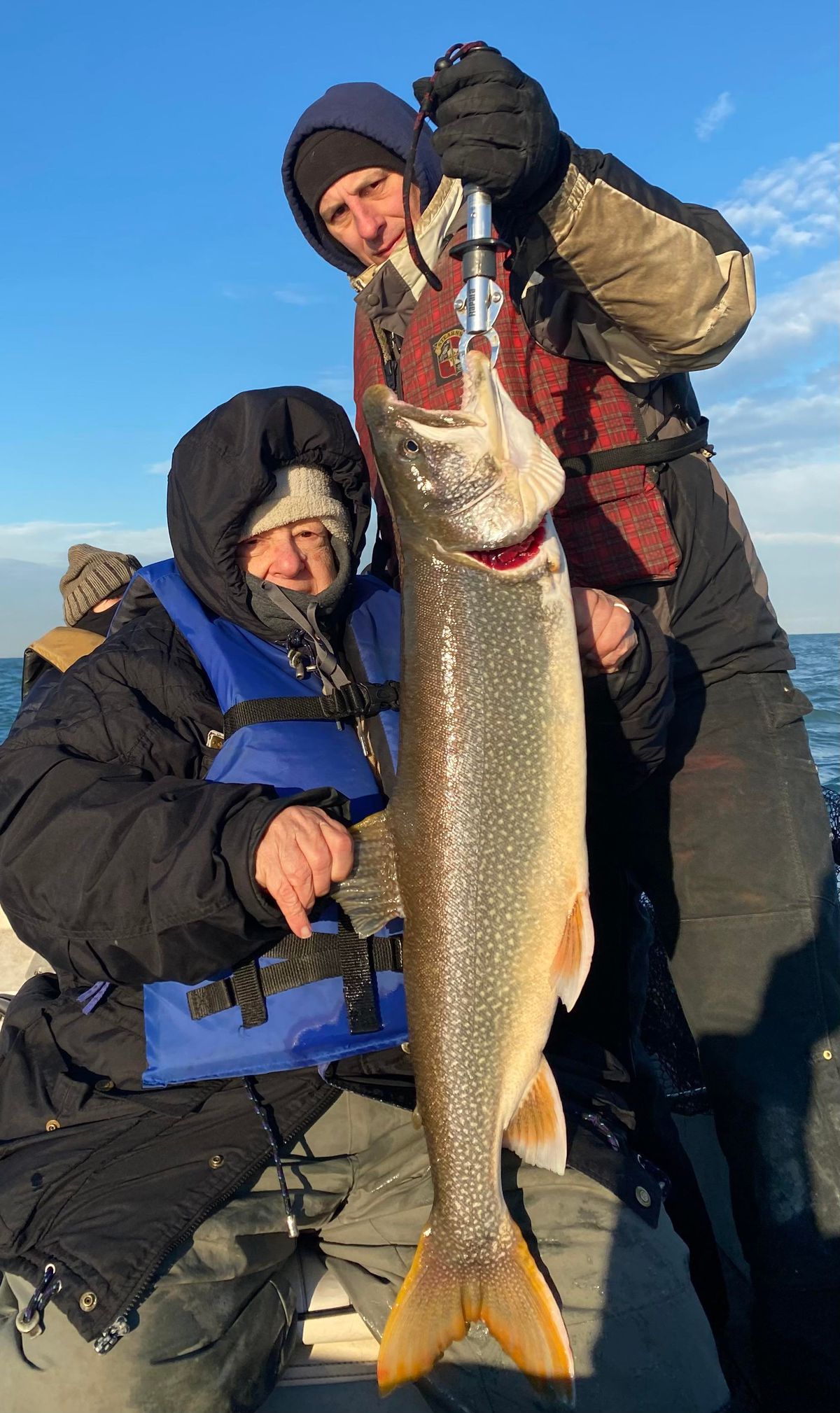 A full view of Anna Simpson (left) and her big lake trout. Provided photo