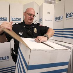 Utah Transit Authority Police Capt. Jason Petersen helps unbox 150 mattresses donated by Leesa Sleep at the Rescue Mission of Salt Lake on World Homeless Day in Salt Lake City on Wednesday, Oct. 10, 2018.