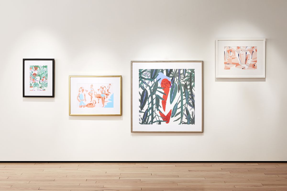 Gallery wall with four colorful prints of abstract figures. 