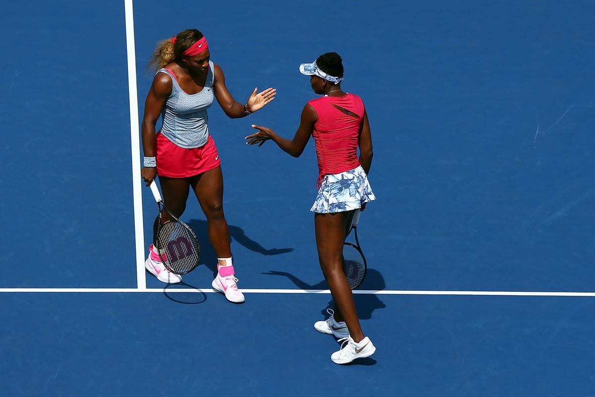 Venus Williams and Serena Williams of the United States against Ekaterina Makarova and Elena Vesnina of Russia during their women’s doubles quarterfinal match on Day Nine of the 2014 US Open at the USTA Billie Jean King National Tennis Center on September 2, 2014 in the Flushing neighborhood of the Queens borough of New York City.