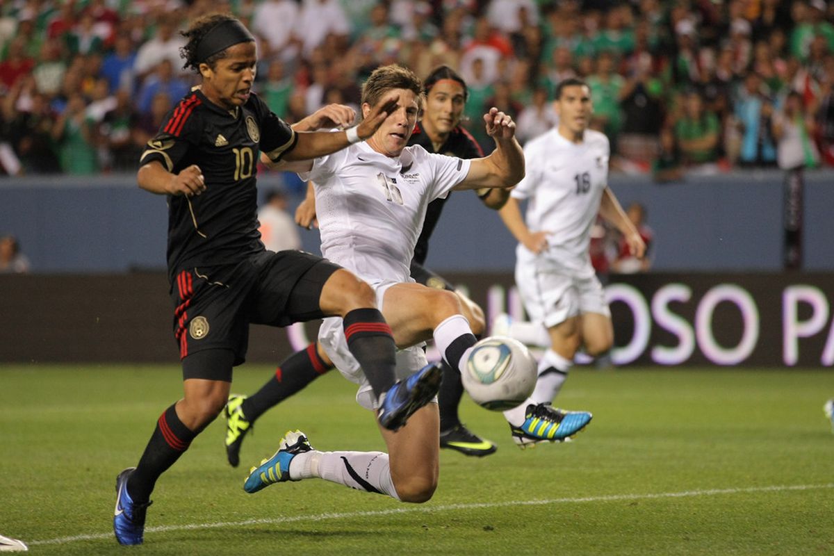 DENVER, CO - JUNE 01:  Giovani Dos Santos #10 of Mexico pressures the goal against Andrew Boyens #15 of New Zealand at INVESCO Field at Mile High on June 1, 2011 in Denver, Colorado.  (Photo by Doug Pensinger/Getty Images)