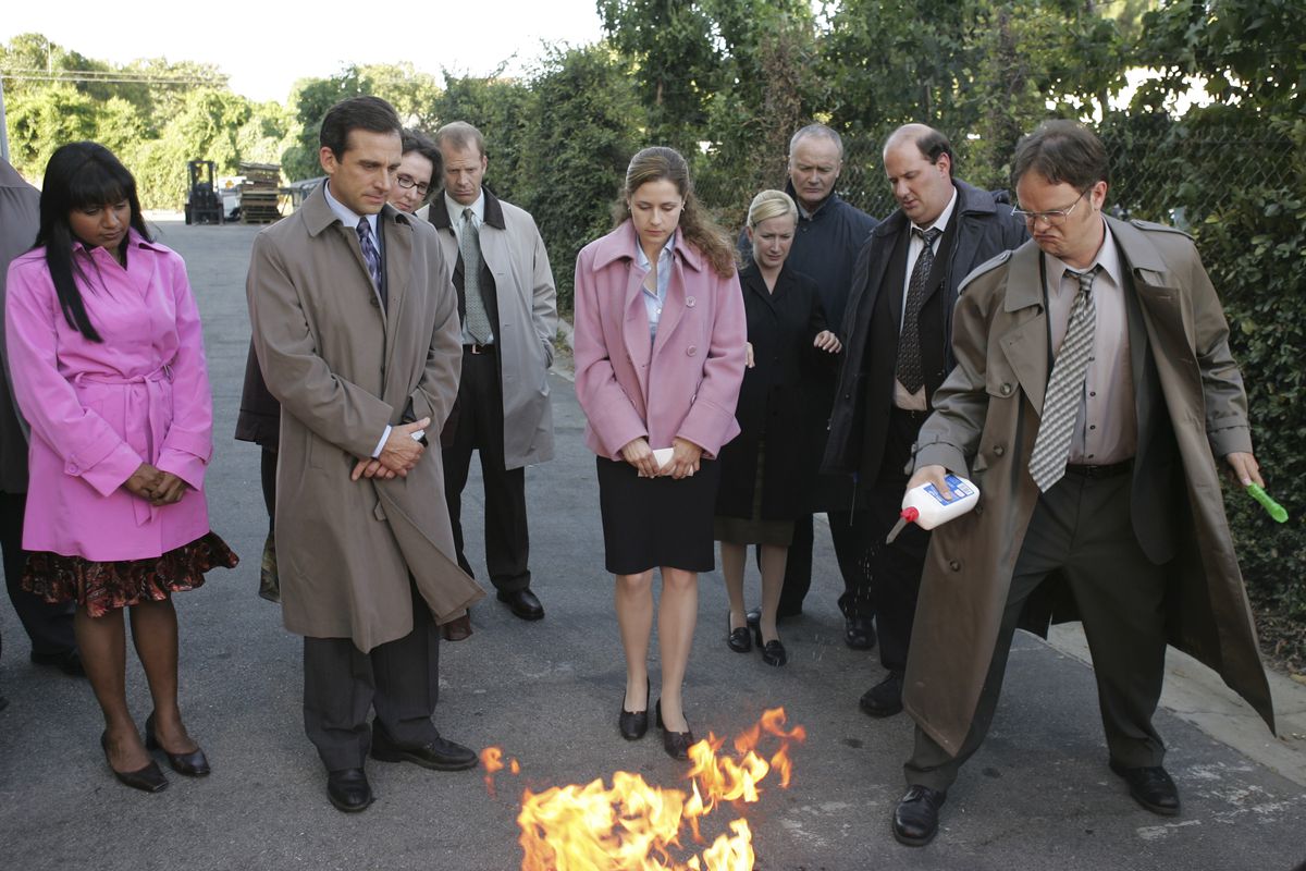 the cast of the office burns a pile of paper in the parking lot