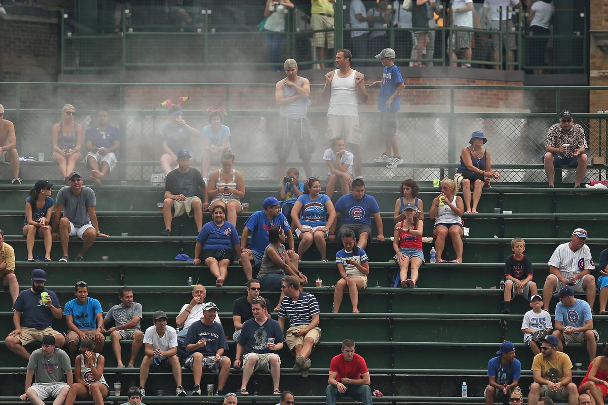 Water misters cool fans in the right field bleachers as the Chicago Cubs take on the Miami Marlins at Wrigley Field in Chicago, Illinois. (Photo by Jonathan Daniel/Getty Images)